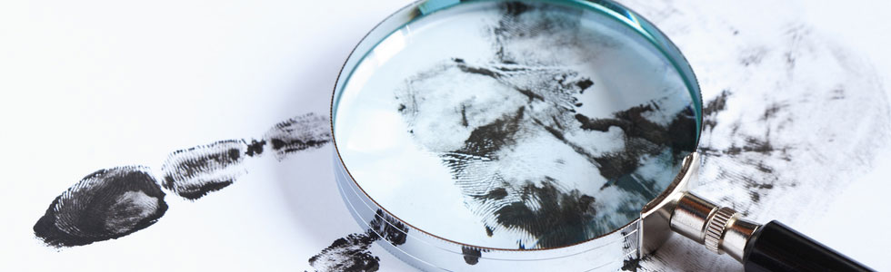 Magnifying glass and hand print